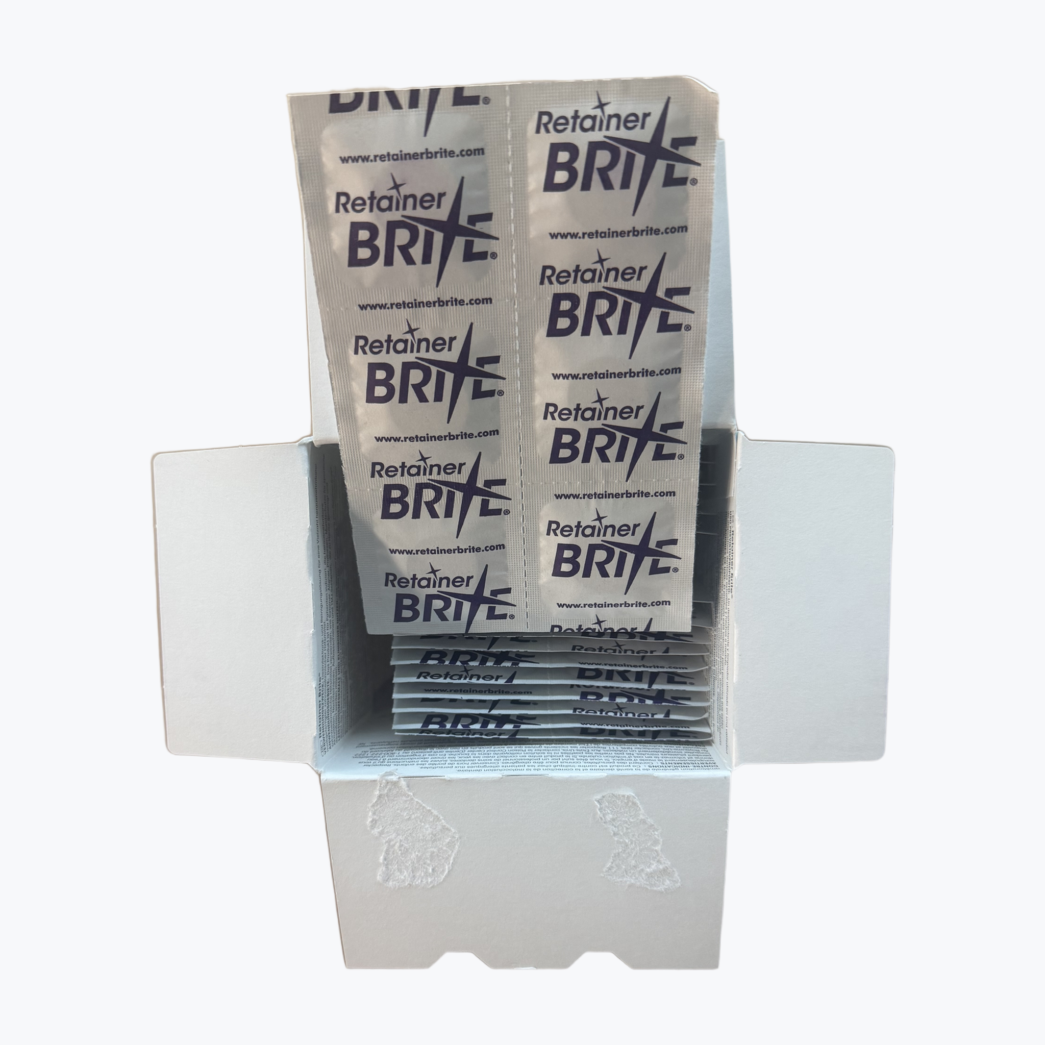 Geopende doos Retainer Brite met een strip individueel verpakte tabletten
