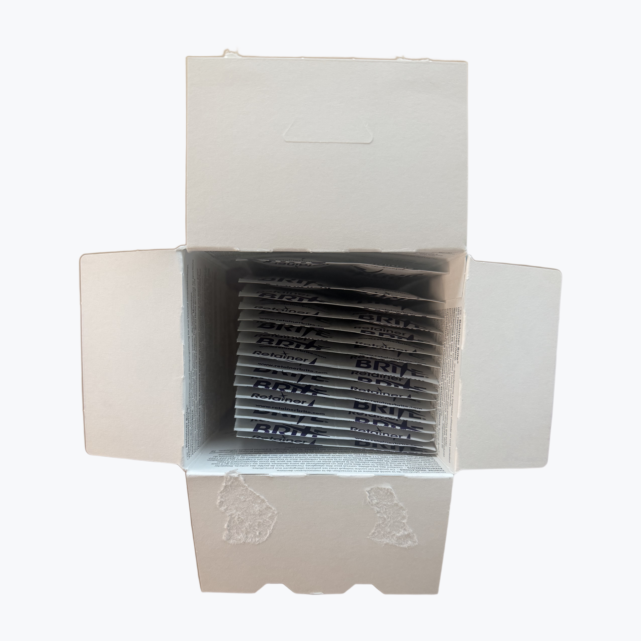 Geopende doos Retainer Brite met de sachets rechtop in de verpakking